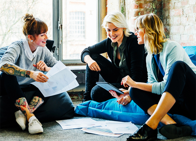 Group of colleagues having meeting sat down with paperwork