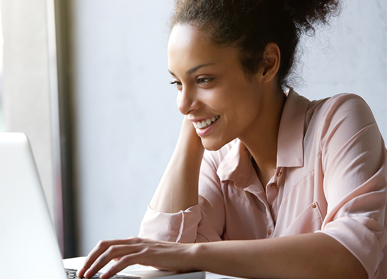 Woman smiling at laptop