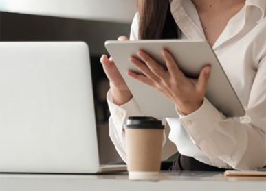 woman holding tablet device