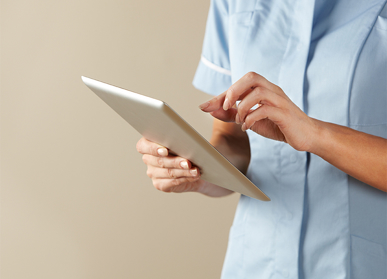 nurse working on an ipad