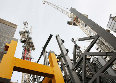 View of looking up at industrial cranes