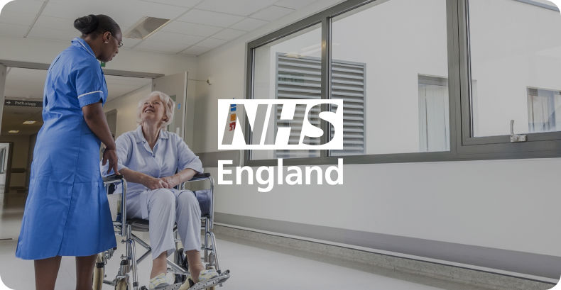 Nurse and patient talking in hallway of hospital