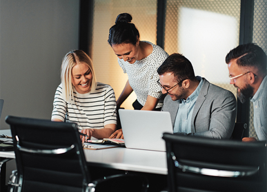 group of colleagues smiling at book